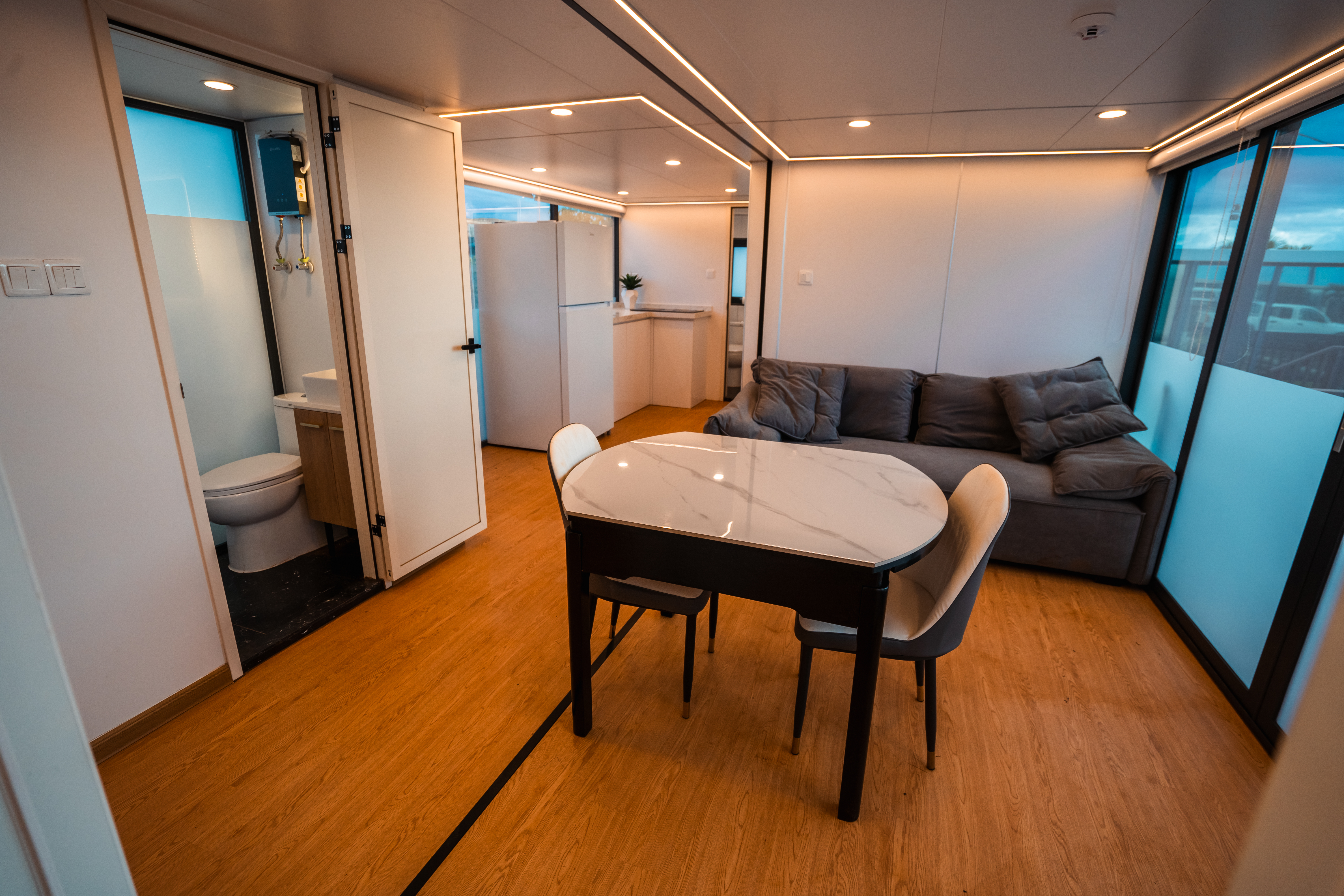 Double Unit living area — dining table, sofa, open floor plan