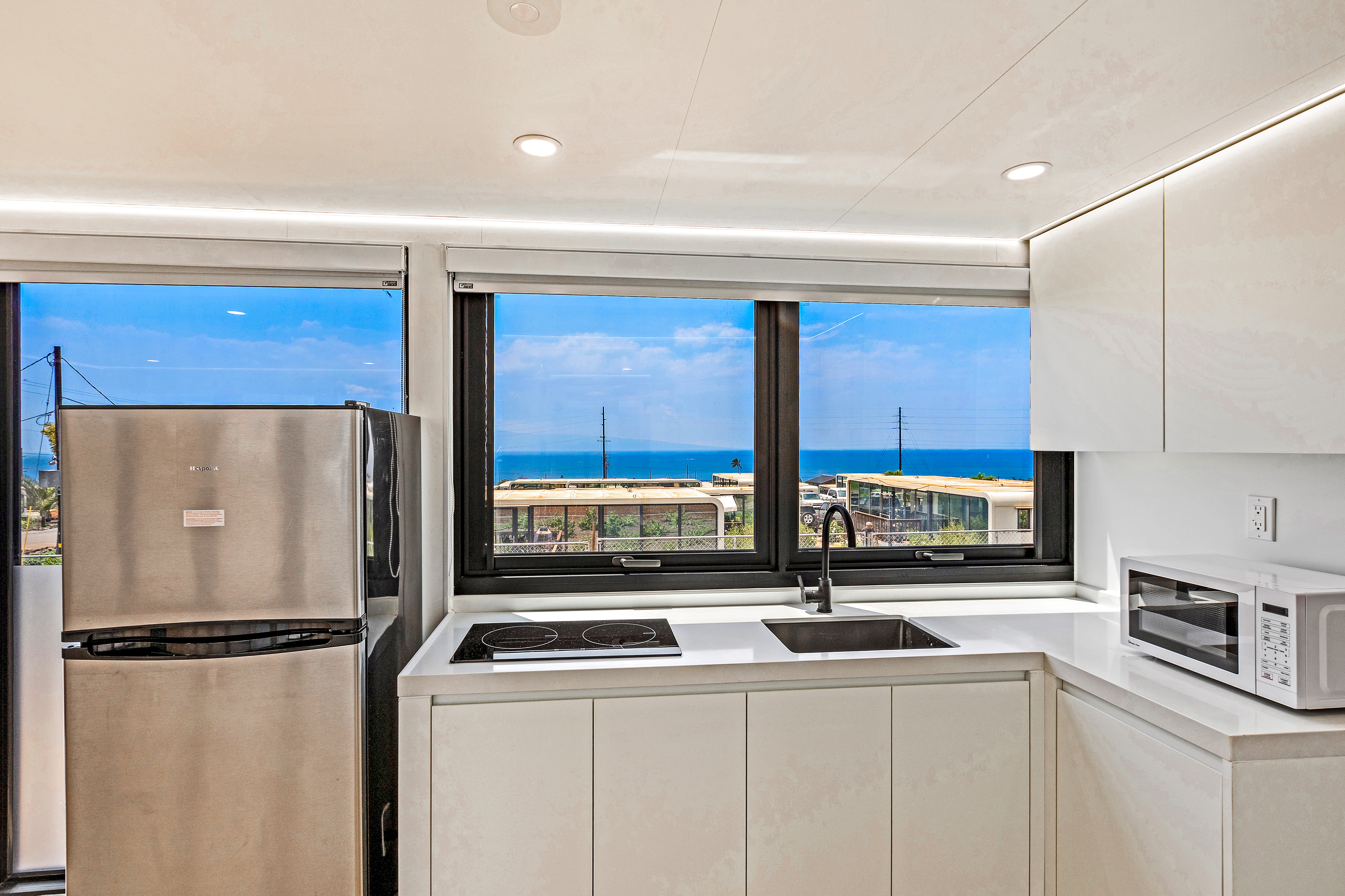 Double Unit kitchen — induction cooktop, full fridge, ocean view