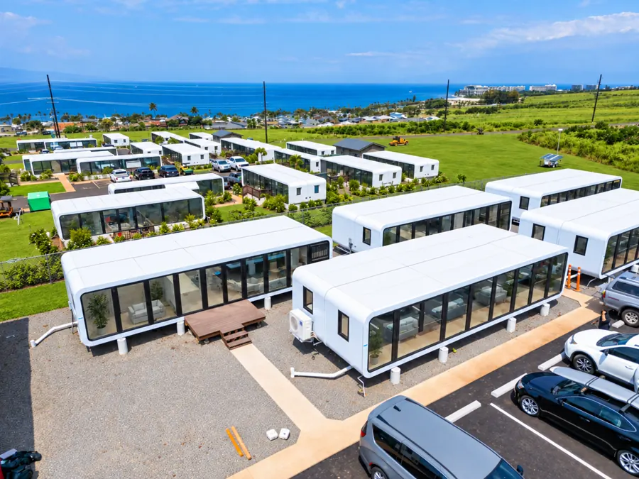 NanoNest modular units deployed for Lahaina wildfire housing in Maui, with the Pacific Ocean behind